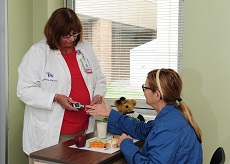 Patient getting her blood sugar tested