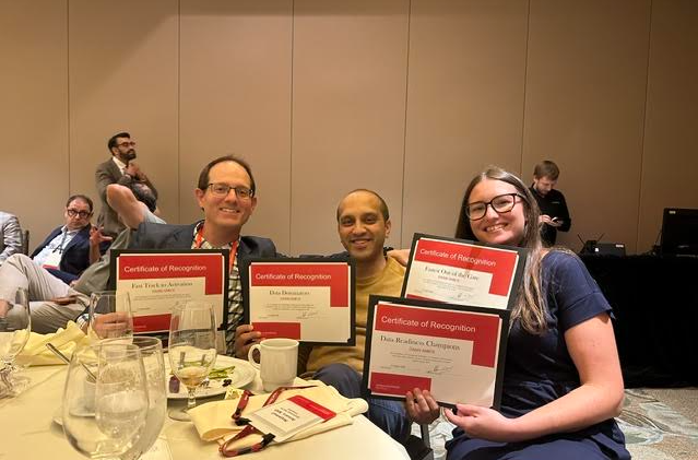 Robert Sturm III MD, Najamul Ansari MD and Jessica Carter BSN RN holding up certificates at the last OASIS Investigator Quarterly Meeting accepting TriHealth Team Recognition and 6 national site awards