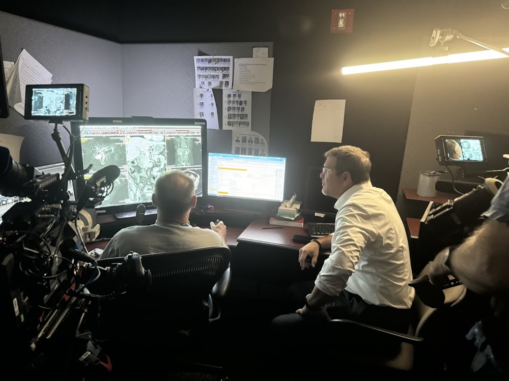 filming providers reviewing a scan