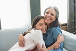 mother hugging teenage daughter