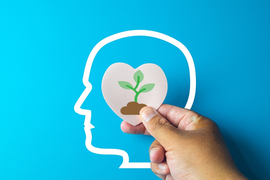 outline of head with paper plant in middle