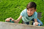 kid climbing rock wall playground